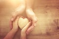 Father and little child holding together wooden heart. Happy father`s day concept Royalty Free Stock Photo