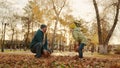 father with little child kid throws autumn leaves sunlight glare. autumn sunset park. laughing happy family. child has Royalty Free Stock Photo