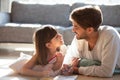 Father little daughter lying on floor drawing and talking Royalty Free Stock Photo