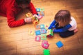 Father and little daughter playing with puzzle, early education Royalty Free Stock Photo