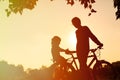 Father and little daughter riding bike at sunset Royalty Free Stock Photo