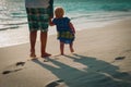 father and little daughter walk on sunset beach Royalty Free Stock Photo