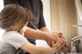Father and little daughter washing hands during pandemic lockdown Royalty Free Stock Photo