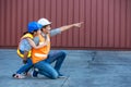 Father and little daughter wearing a safety helmet at Container cargo site. Business heir concept. Happy father and daughter weari