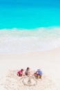 Father and little daughters making sand castle at tropical beach. Top view of family playing on the beach Royalty Free Stock Photo