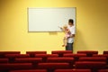 Father and little girl in empty presentation hall Royalty Free Stock Photo