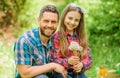 Father and little girl enjoy summertime. Dad and daughter blowing dandelion seeds. Keep allergies from ruining your life Royalty Free Stock Photo
