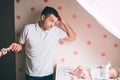 Father and little kid in the nursery. The first year of life. Uncertainty and fear of a child. Daddy does not know what Royalty Free Stock Photo