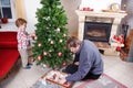 Father and little son decorating christmas tree at home Royalty Free Stock Photo