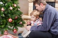 Father and little son decorating christmas tree at home Royalty Free Stock Photo