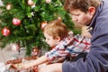 Father and little son decorating christmas tree at home Royalty Free Stock Photo