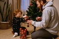 Father and little son decorating Christmas tree at home Royalty Free Stock Photo