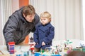 Father and little son having fun on toy exposition, indoors. Royalty Free Stock Photo