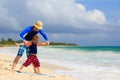 Father and little son learning surfing at the