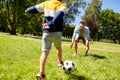 Father with little son playing soccer at park Royalty Free Stock Photo