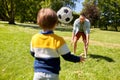 Father with little son playing soccer at park Royalty Free Stock Photo