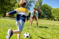 Father with little son playing soccer at park Royalty Free Stock Photo