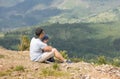 Father and little son are sitting on the top of the mountain. The boy trusts dad. Lack of fear. Father and son relationship Royalty Free Stock Photo