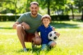 Father and little son with soccer ball at park Royalty Free Stock Photo