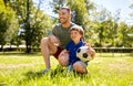 Father and little son with soccer ball at park Royalty Free Stock Photo