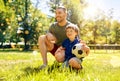 father and little son with soccer ball at park Royalty Free Stock Photo