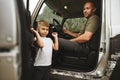 Father and little son standing near car on road trip Royalty Free Stock Photo