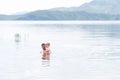 Father with little son swimmind in sea, beautiful landscape sea and mountines