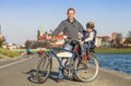 Father with little son walk togeter on bike in city Royalty Free Stock Photo