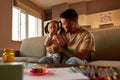 Father look at daughter in his arms eat jelly Royalty Free Stock Photo