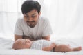 Father looking at his baby son`s face while sleeping on the bed Royalty Free Stock Photo