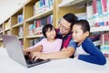 Father looking at his daughter proudly in library