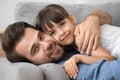 Father lying hugging with lovely daughter at home Royalty Free Stock Photo