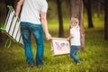 Father making birdhouse with daughter