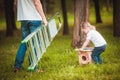 Father making birdhouse with daughter