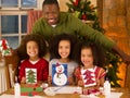 Father making Christmas cards with children