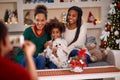 Father making photo of mother with two daughters for Christmas Royalty Free Stock Photo