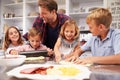 Father making pizza with his kids Royalty Free Stock Photo