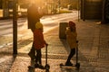 Father with masks and two kids on bike crossing the street