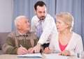 Woman and eldery man signing agreement