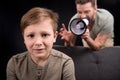 Father with megaphone screaming at scared little son Royalty Free Stock Photo