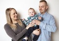 A father and mother with the baby boy on studio white background Royalty Free Stock Photo