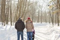 Father and mother with baby carriage in winter forest Royalty Free Stock Photo