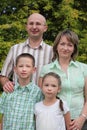 Father, mother, boy and girl in early fall park