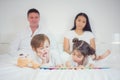 Brothers and sister read a bedtime story togather Royalty Free Stock Photo