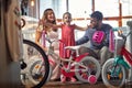 Father and mother buying new bicycle for little girl in bike shop
