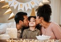 Father, mother and child at birthday party, kiss and happy with celebration, care and bonding in family house. Dad, mom Royalty Free Stock Photo