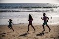 Father, mother and child jogging on the beach. Concept healthy family lifestyle. Summer people vacation at sea. Sport Royalty Free Stock Photo