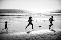 Father, mother and child run on the beach. Concept healthy family lifestyle. Summer people running, parents and child on Royalty Free Stock Photo