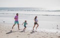 Father, mother and child run on the beach. Concept healthy family lifestyle. Summer people vacation at sea. Healthy Royalty Free Stock Photo