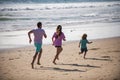 Father, mother and child running jogging on the beach. Concept healthy family lifestyle. Summer people vacation at sea. Royalty Free Stock Photo